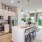 Spacious kitchen with an island and stainless steel appliances inside homes at Cadia Grand Prairie