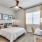 Furnished bedroom with a large window inside a townhome at Cadia Grand Prairie
